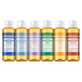 Set of Dr. Bronner's Magic Soaps in various scents on a white background