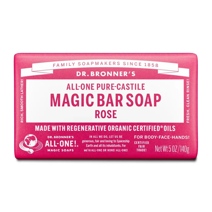 A bar of Dr. Bronners All One Pure Castile Magic Bar Soap, Rose, sits packaged with text emphasizing regenerative organic certified oils, suitable for body, face, and hands. Net Wt 5 oz140g [5 oz]
